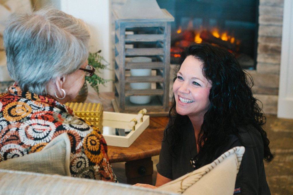 A woman smiling at another woman using the respite care service at Alcoa Pines Nursing home