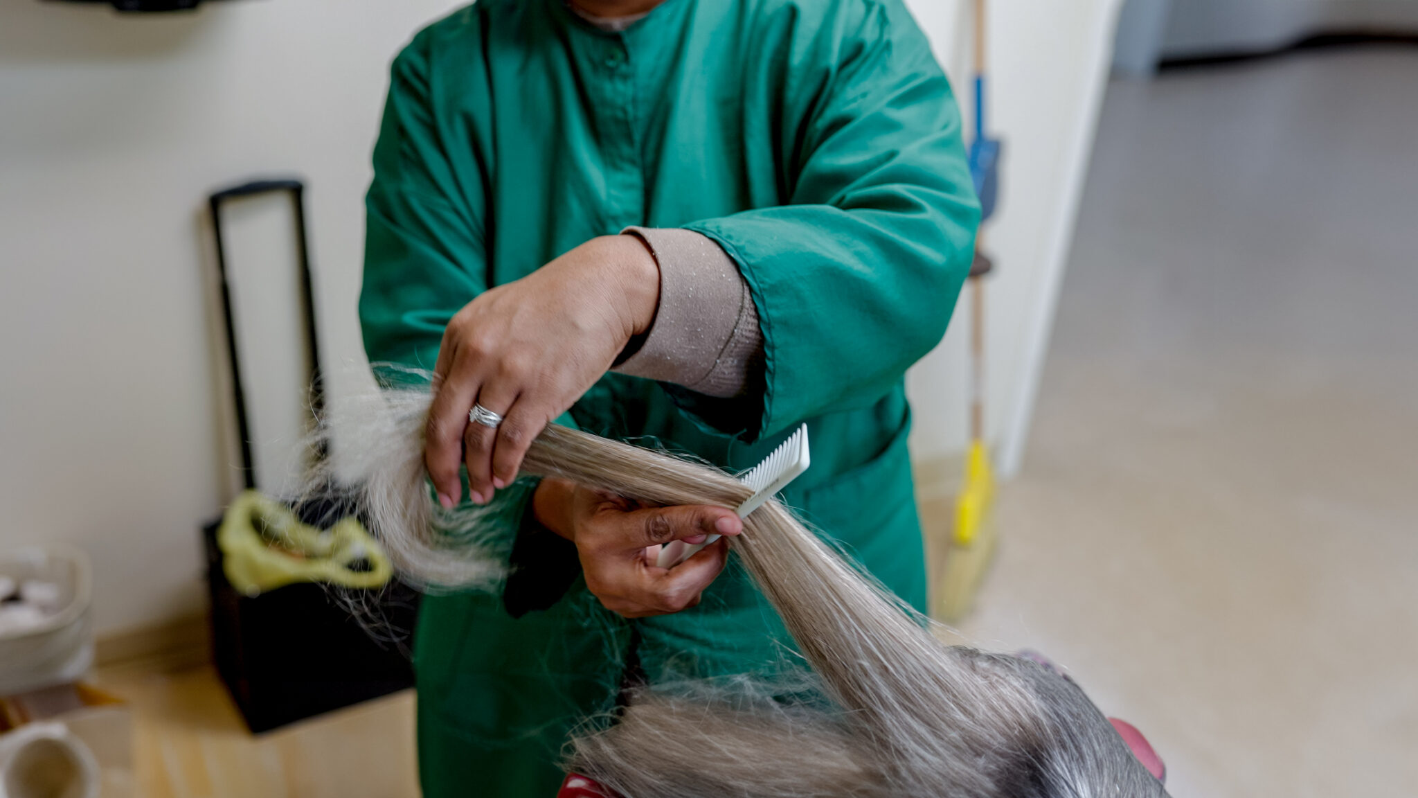 A Salon stylist in a Alcoa Pines Nursing home styling a resident's hair